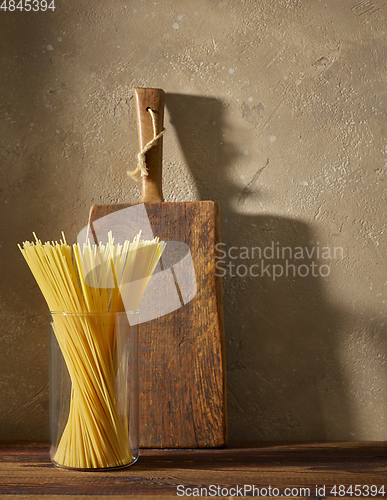 Image of spaghetti pasta on brown wooden shelf