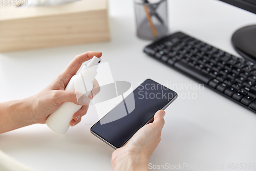 Image of close up of woman cleaning smartphone