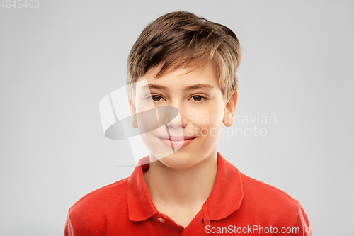 Image of portrait of happy smiling boy in red polo t-shirt