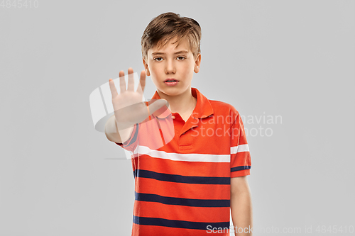 Image of portrait of boy making stopping gesture