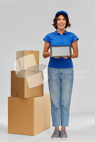 Image of delivery girl with parcel boxes and tablet pc