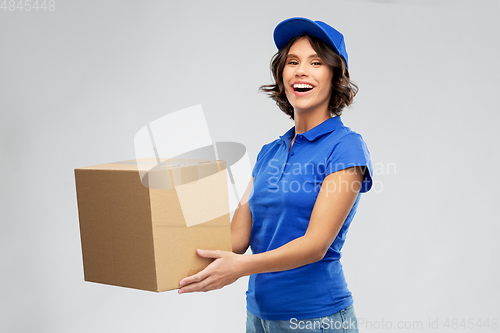 Image of happy delivery girl with parcel box in blue