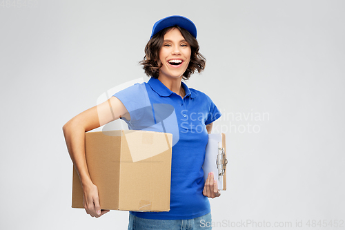 Image of happy delivery girl with parcel box and clipboard