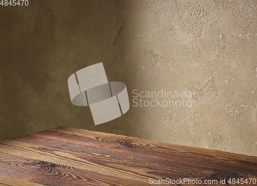 Image of beige color wall and wooden table