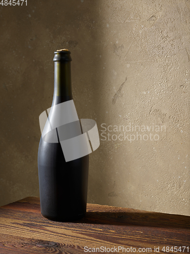 Image of whine bottle on wooden table