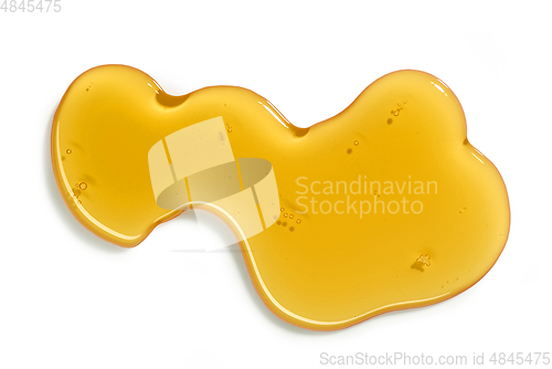 Image of flowing honey on white background