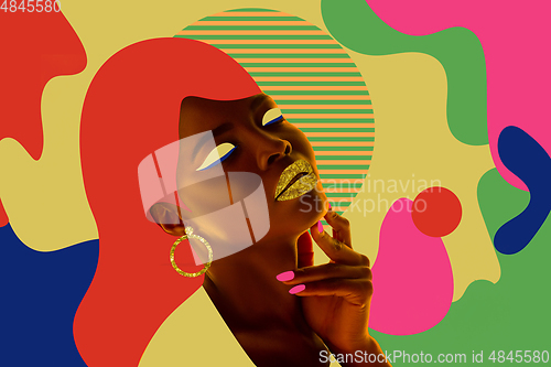 Image of Portrait of a beautiful young woman with bright colorful painted design