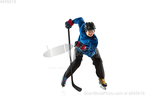 Image of Young female hockey player with the stick on ice court and white background