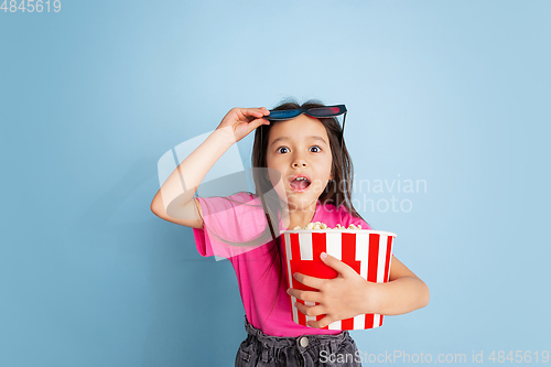 Image of Caucasian little girl\'s portrait on blue studio background