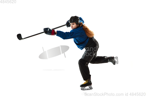 Image of Young female hockey player with the stick on ice court and white background