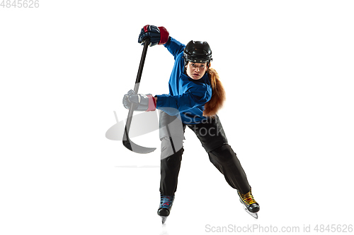 Image of Young female hockey player with the stick on ice court and white background