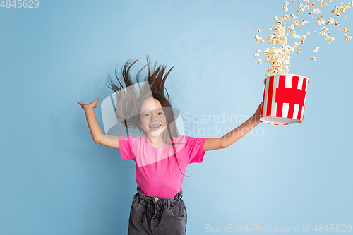 Image of Caucasian little girl\'s portrait on blue studio background