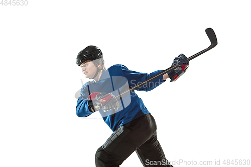 Image of Young female hockey player with the stick on ice court and white background
