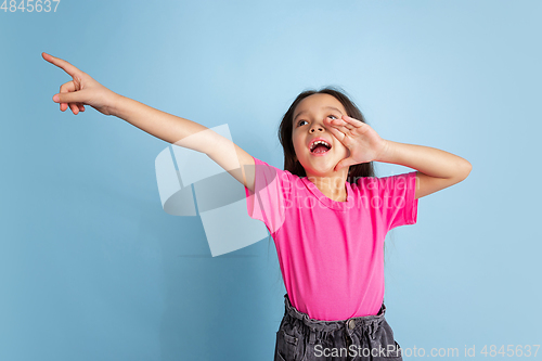 Image of Caucasian little girl\'s portrait on blue studio background
