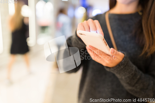 Image of Woman reading on cellphone