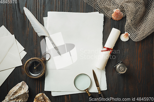 Image of Old fashioned flat lay with letters writing accessories on dark wooden background