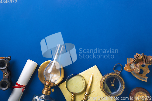 Image of Old fashioned flat lay with retro accessories on blue background