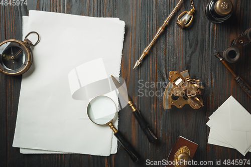 Image of Old fashioned flat lay with letters writing accessories on dark wooden background