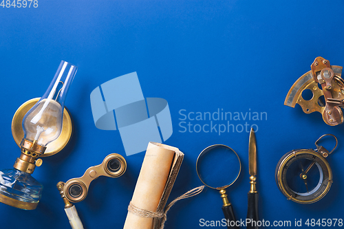 Image of Old fashioned flat lay with retro accessories on blue background