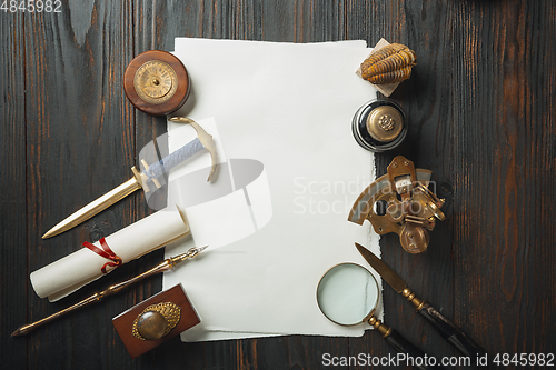 Image of Old fashioned flat lay with letters writing accessories on dark wooden background