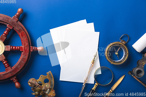 Image of Old fashioned flat lay with retro accessories on blue background