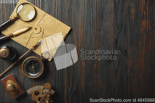 Image of Old fashioned flat lay with letters writing accessories on dark wooden background