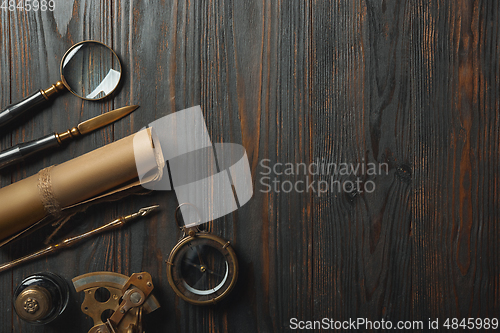 Image of Old fashioned flat lay with letters writing accessories on dark wooden background