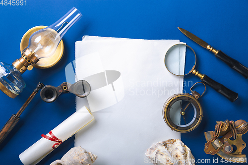 Image of Old fashioned flat lay with retro accessories on blue background