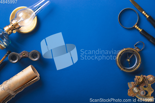 Image of Old fashioned flat lay with retro accessories on blue background