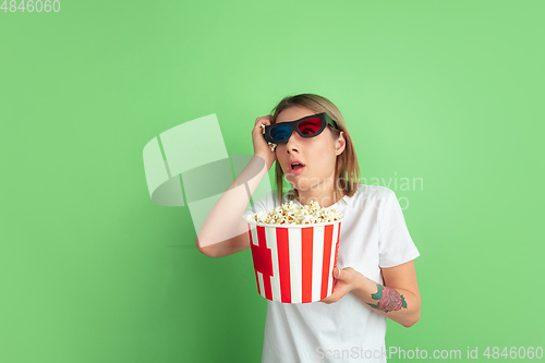 Image of Caucasian young woman\'s portrait on green studio background