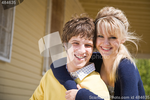 Image of Caucasian couple in front of house