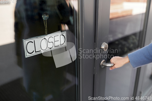 Image of hand trying to open closed office door