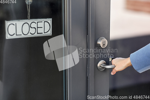 Image of hand trying to open closed office door