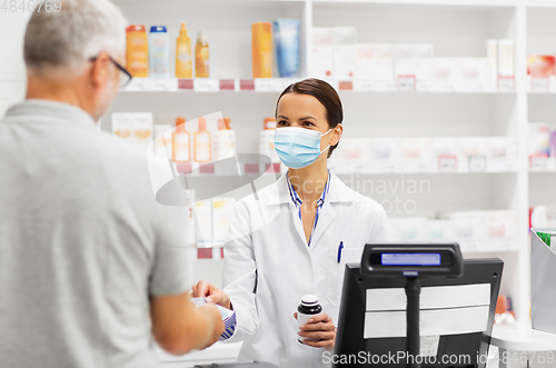 Image of apothecary selling drug to senior man at pharmacy