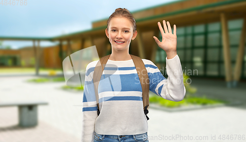 Image of smiling teenage student girl with school bag