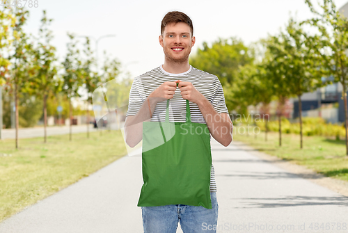 Image of man with reusable canvas bag for food shopping