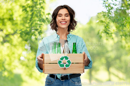 Image of smiling young woman sorting glass waste