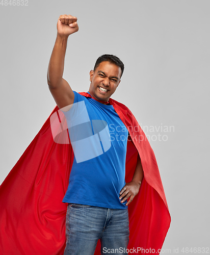 Image of indian man in superhero cape makes winning gesture