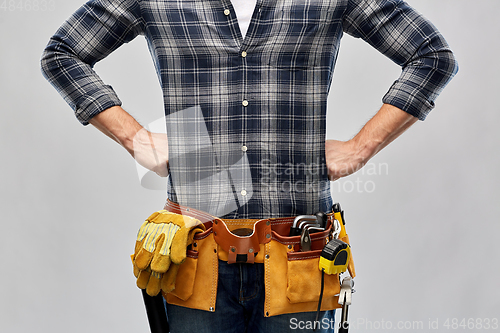 Image of male worker or builder with working tools on belt