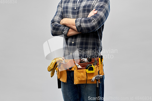 Image of male worker or builder with working tools on belt