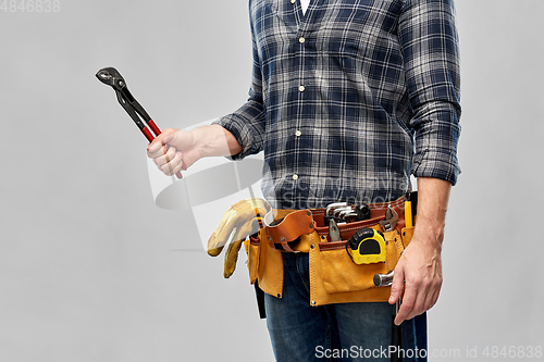 Image of worker or builder with wrench and tools on belt