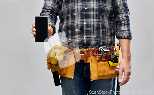 Image of worker or builder with phone and working tools