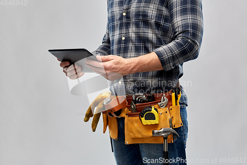 Image of male builder with tablet pc and working tools