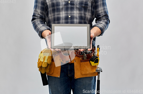 Image of male builder with working tools showing tablet pc