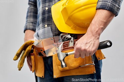 Image of worker or builder with hammer and working tools