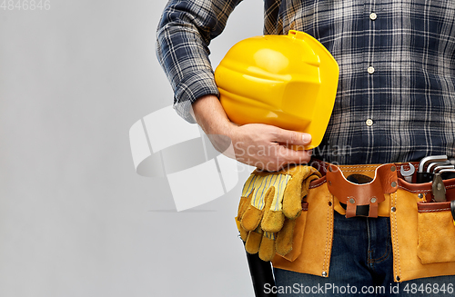 Image of worker or builder with helmet and working tools