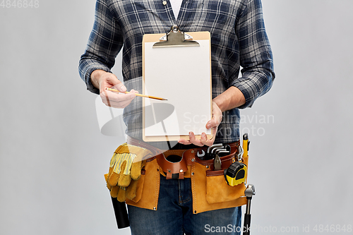 Image of builder with clipboard, pencil and working tools