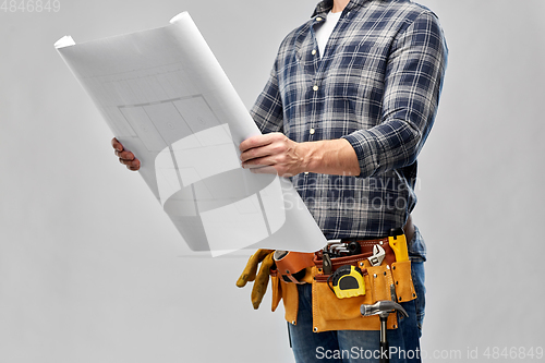 Image of male builder with blueprint and working tools