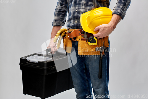 Image of builder with helmet and box of working tools