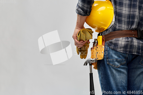 Image of worker or builder with helmet and working tools